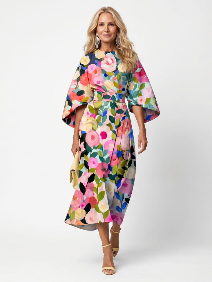 Stylish woman in an elegant floral midi dress, featuring wide sleeves & wrap waist, suitable for occasions.
