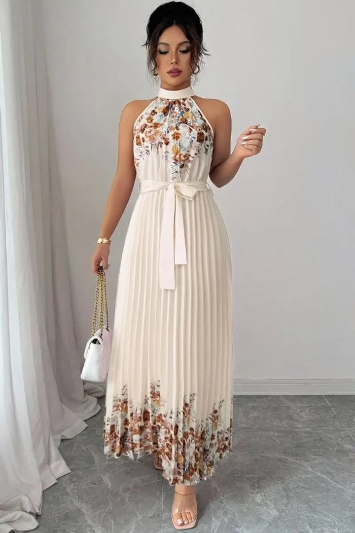 Floral pleated halter maxi dress with chic tie waist, elegant for parties and special events.