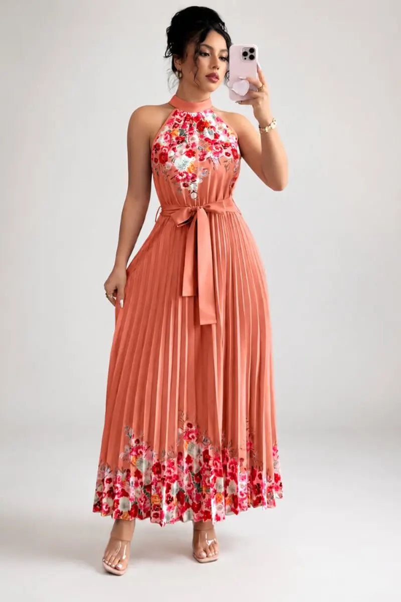 Halter-neck pleated maxi dress with vibrant floral pattern, perfect for summer and spring parties.