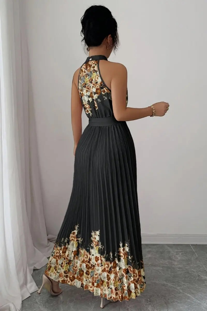 Intricate halter neckline on a floral pleated maxi dress, elegant and stylish for special events.