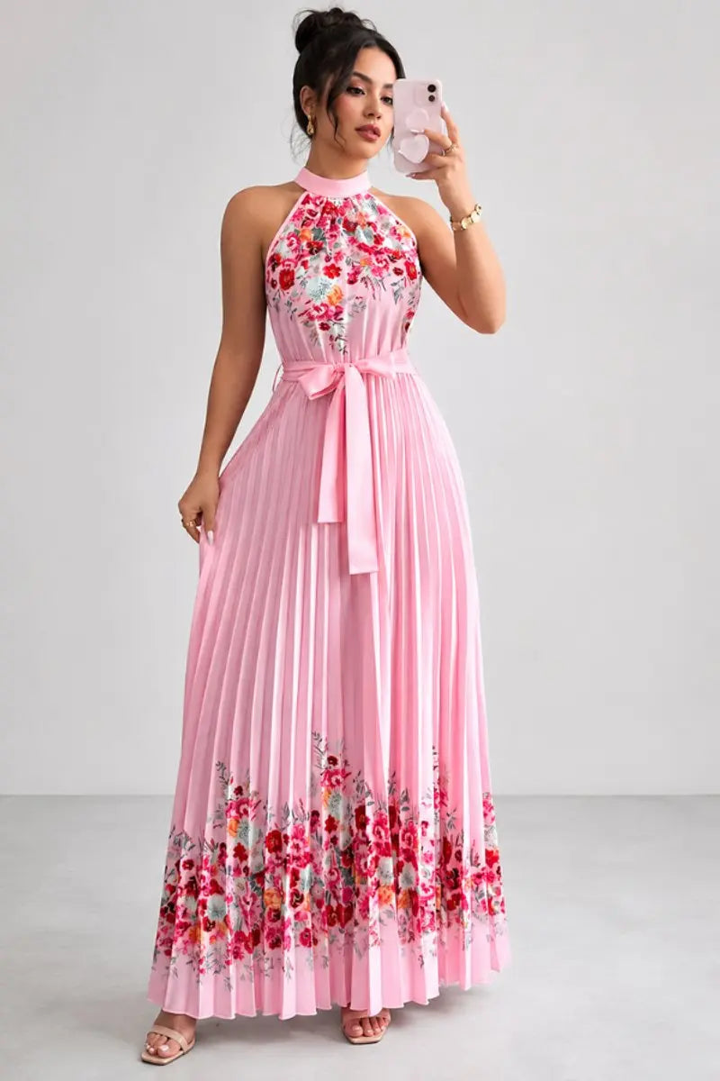 Close-up: Floral print halter-neck pleated maxi dress with flowing design, perfect for occasions.