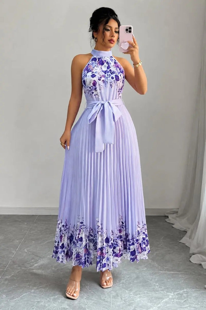 Detailed pleating on a women's floral halter maxi gown, an elegant choice for special events.