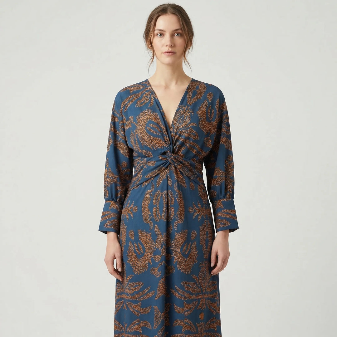 Close-up of chic floral print on an elegant A-line midi dress, ideal for wedding guests or party wear.