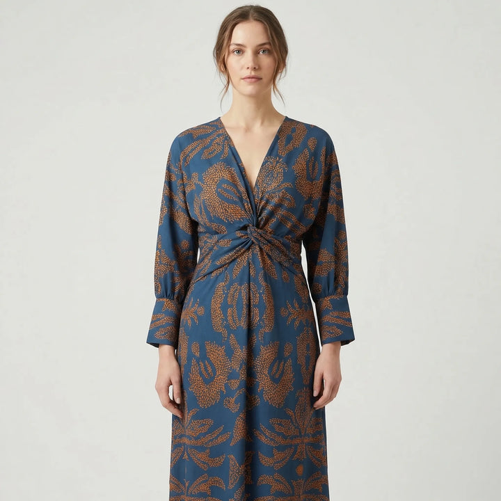 Close-up of chic floral print on an elegant A-line midi dress, ideal for wedding guests or party wear.