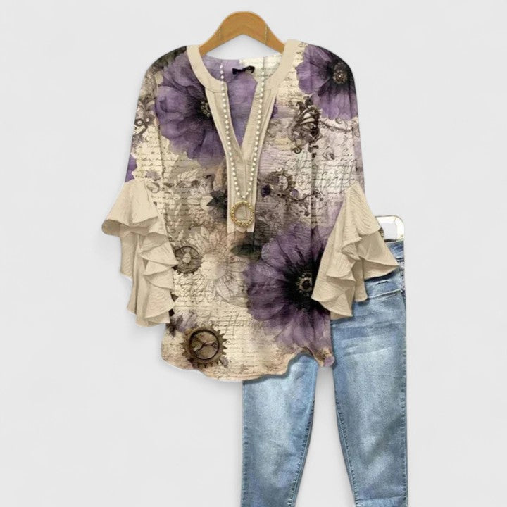 Versatile women's ruffle sleeve floral blouse. Elegant design for both casual and dressy occasions.