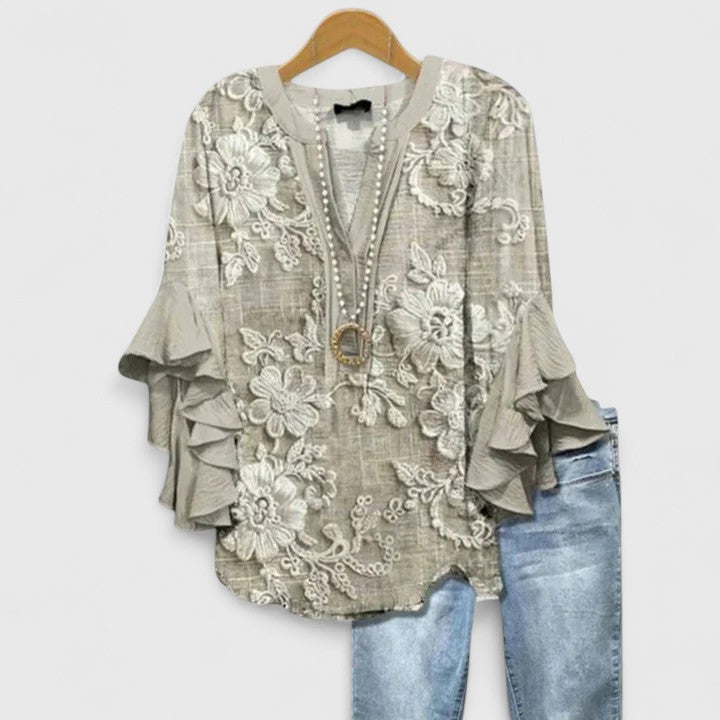 Chic women's ruffle sleeve blouse, vibrant floral print. A versatile elegant top for spring style.