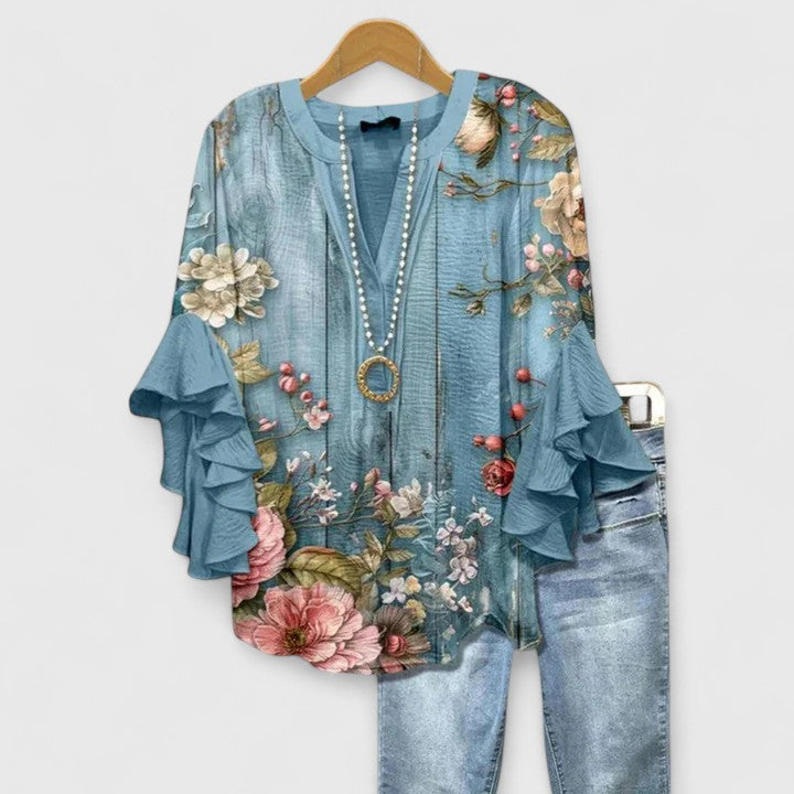 Graceful women's floral blouse featuring sophisticated ruffle long sleeves. Ideal for spring fashion.