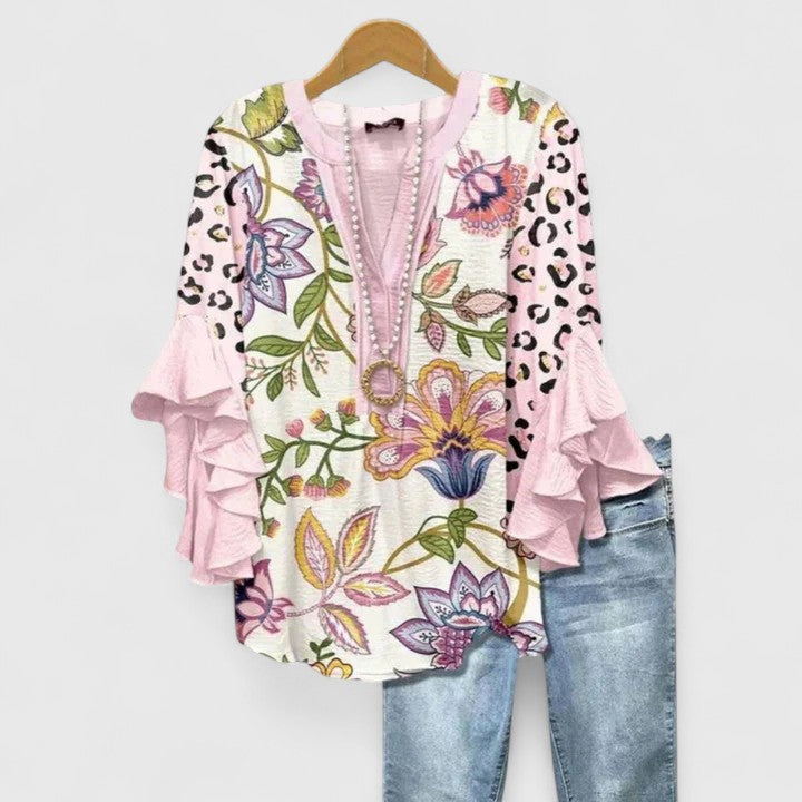 Vibrant floral print women's blouse, elegant ruffle sleeves. Perfect for a chic spring or summer look.