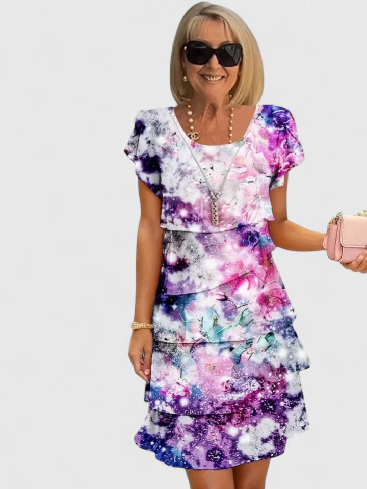 Elegant women's floral tiered dress with short sleeves, perfect for summer casual wear or parties.