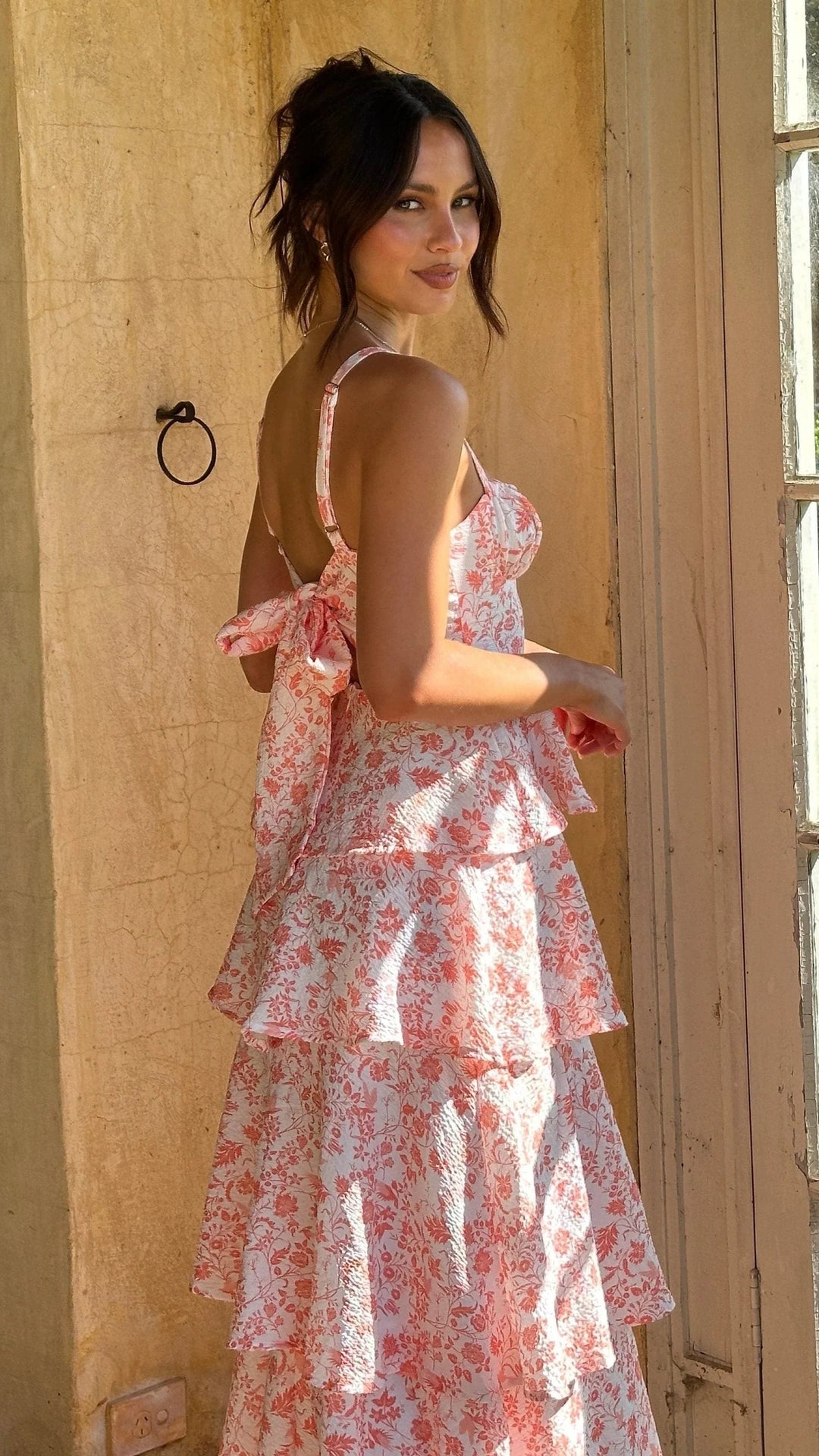 Detailed view of the intricate floral pattern & elegant tiers on this women's maxi wedding guest dress.