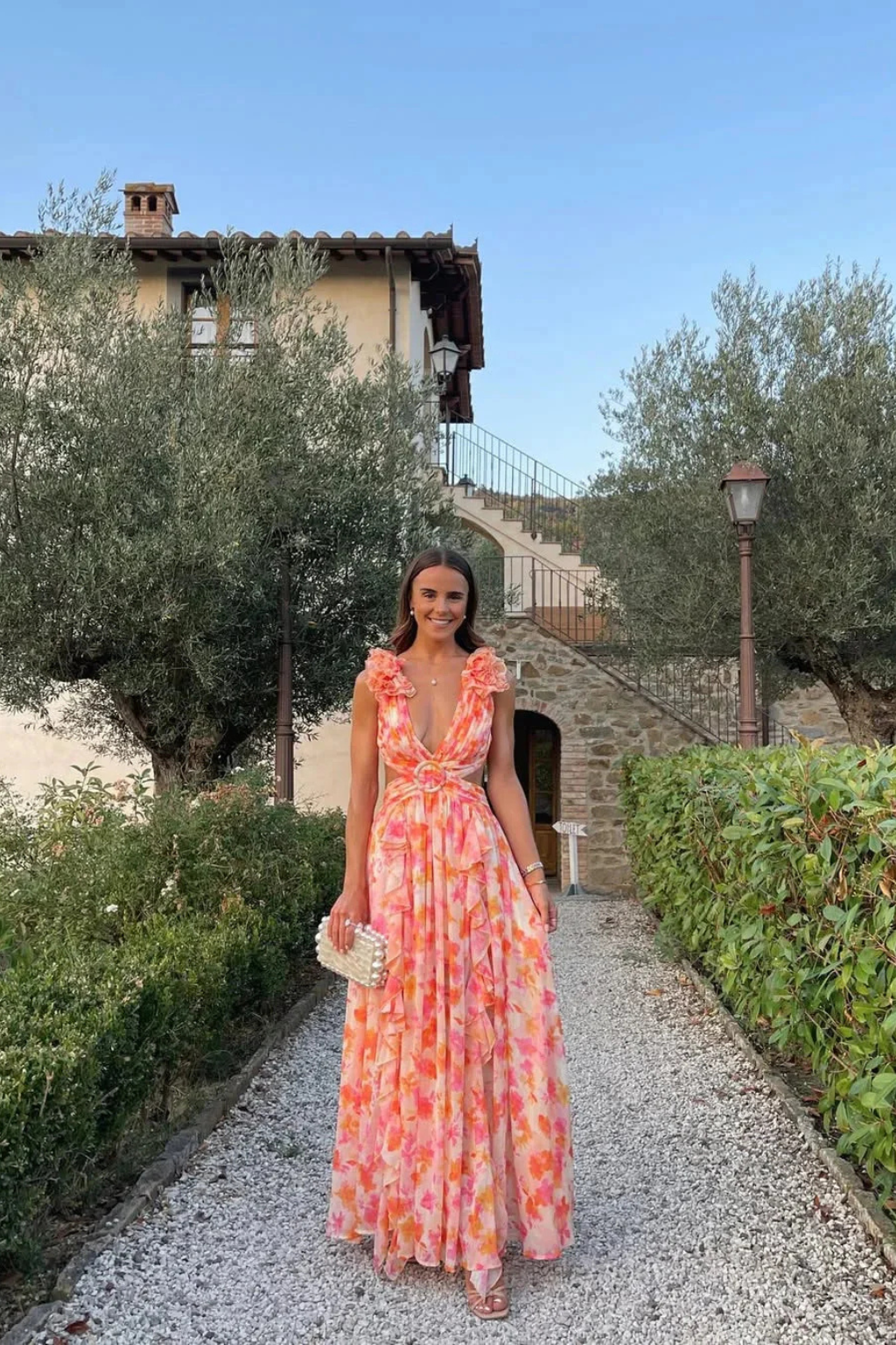 Stylish women's floral maxi dress with a flattering V-neckline and charming ruffled hem, great for guests.