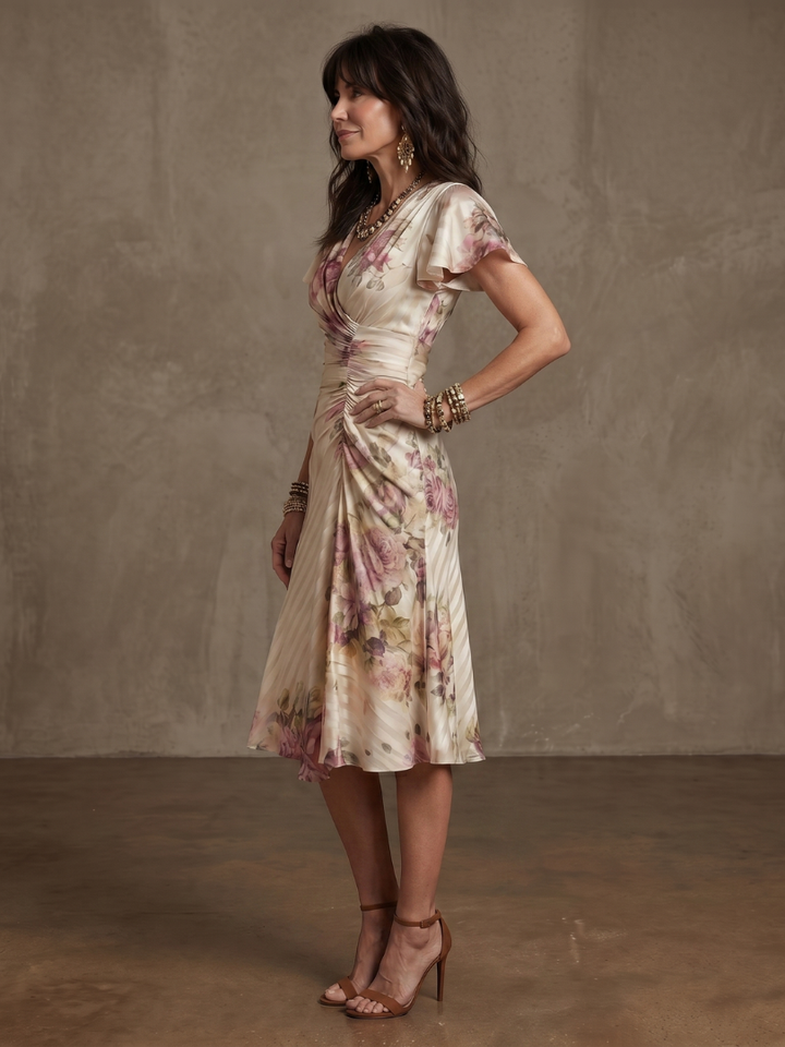 Stylish floral wrap ruched midi dress for women. Features a flattering fit, v-neck, and short sleeves for summer/spring.
