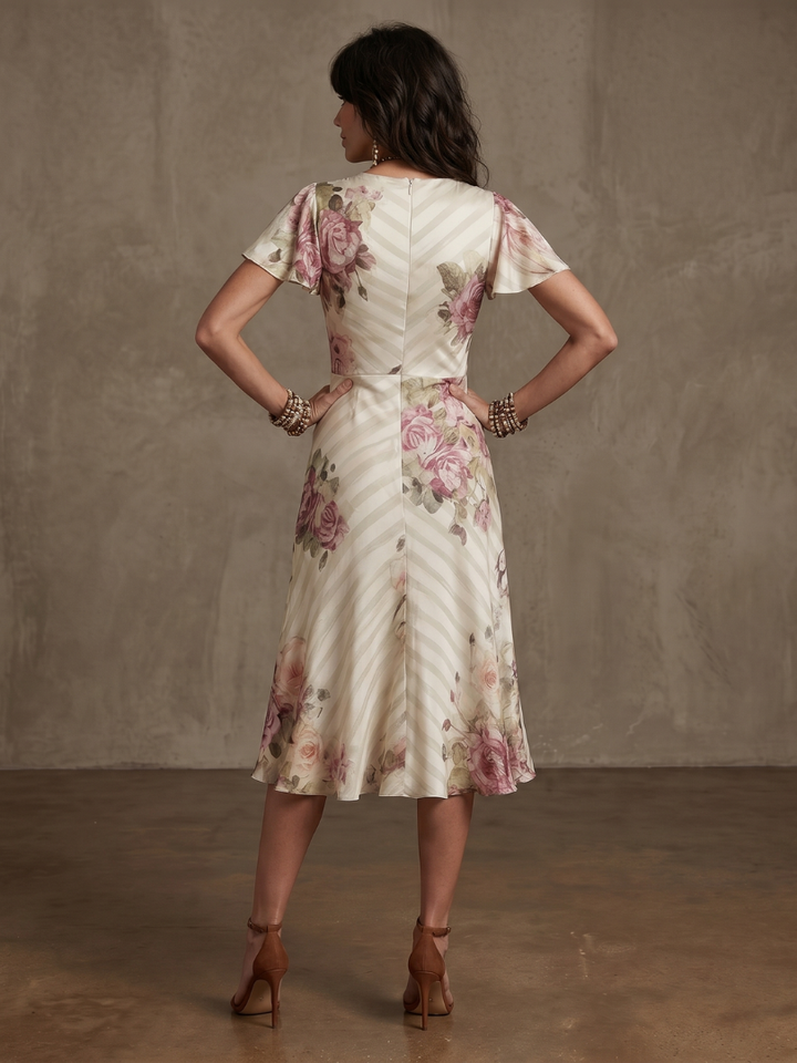 Flattering women's floral wrap ruched midi dress. Elegant day dress with short sleeves and v-neck for spring/summer comfort.