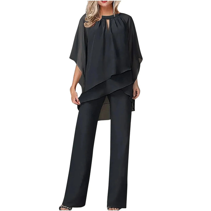 Navy blue women's two-piece set featuring a flowing batwing top & elegant wide-leg pants. Dressy occasion wear.