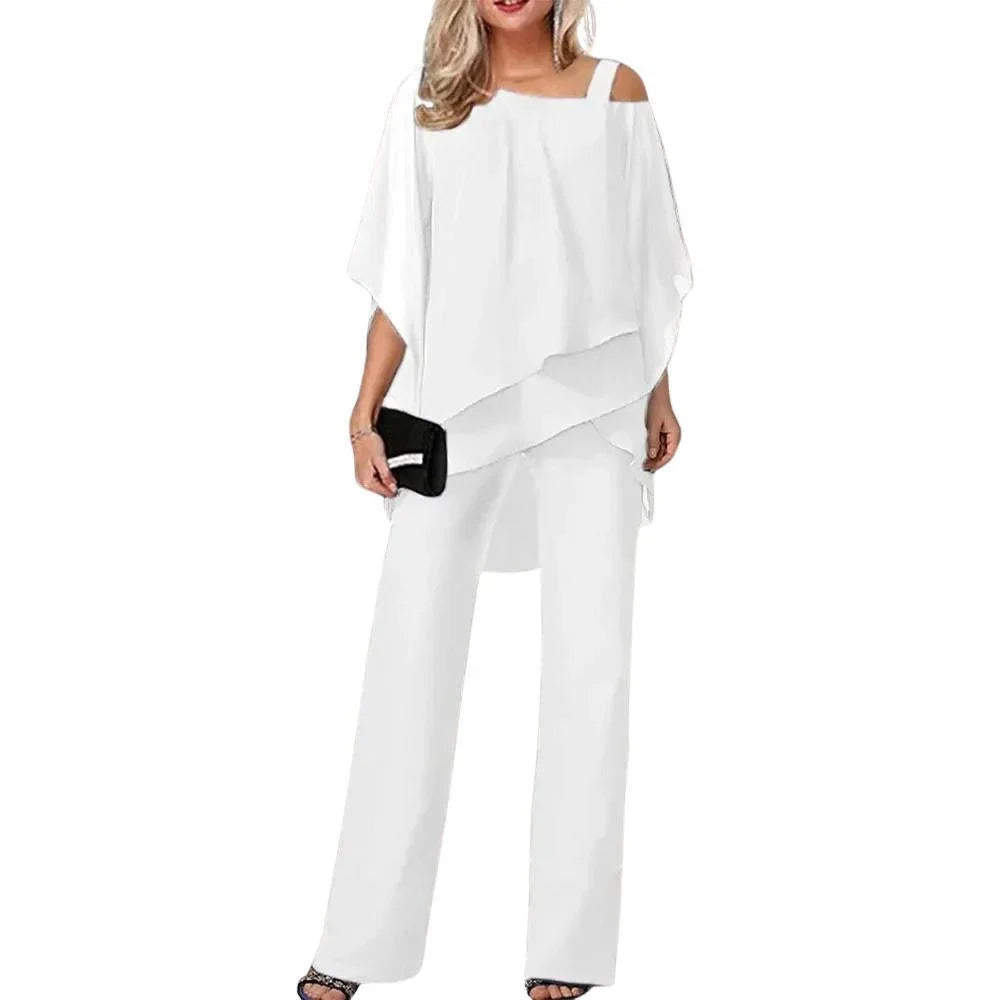 Comfortable black women's flowing top & wide-leg pants set. Stylish, loose-fit formal outfit with batwing sleeves.