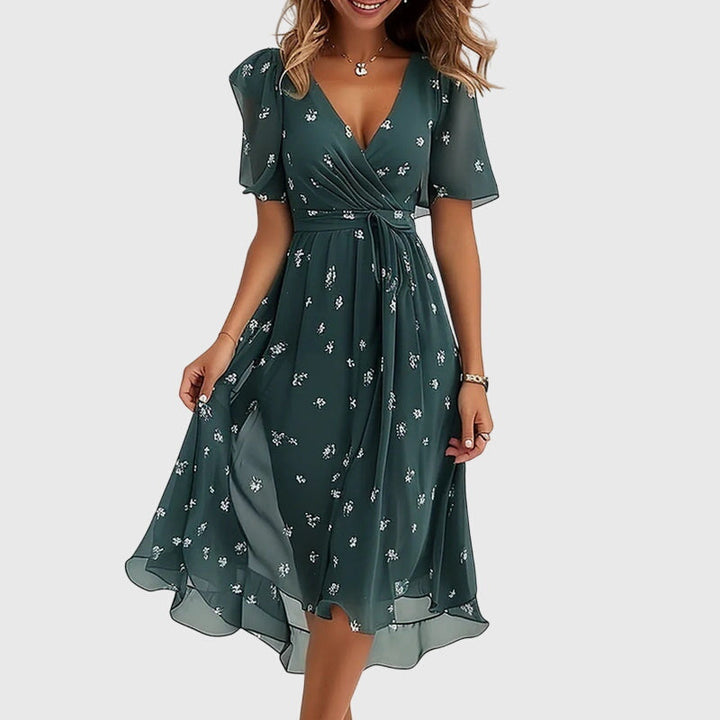 Chic & comfortable women's flowy midi dress. Flattering fit, V-neck, flutter sleeves for summer parties or casual.
