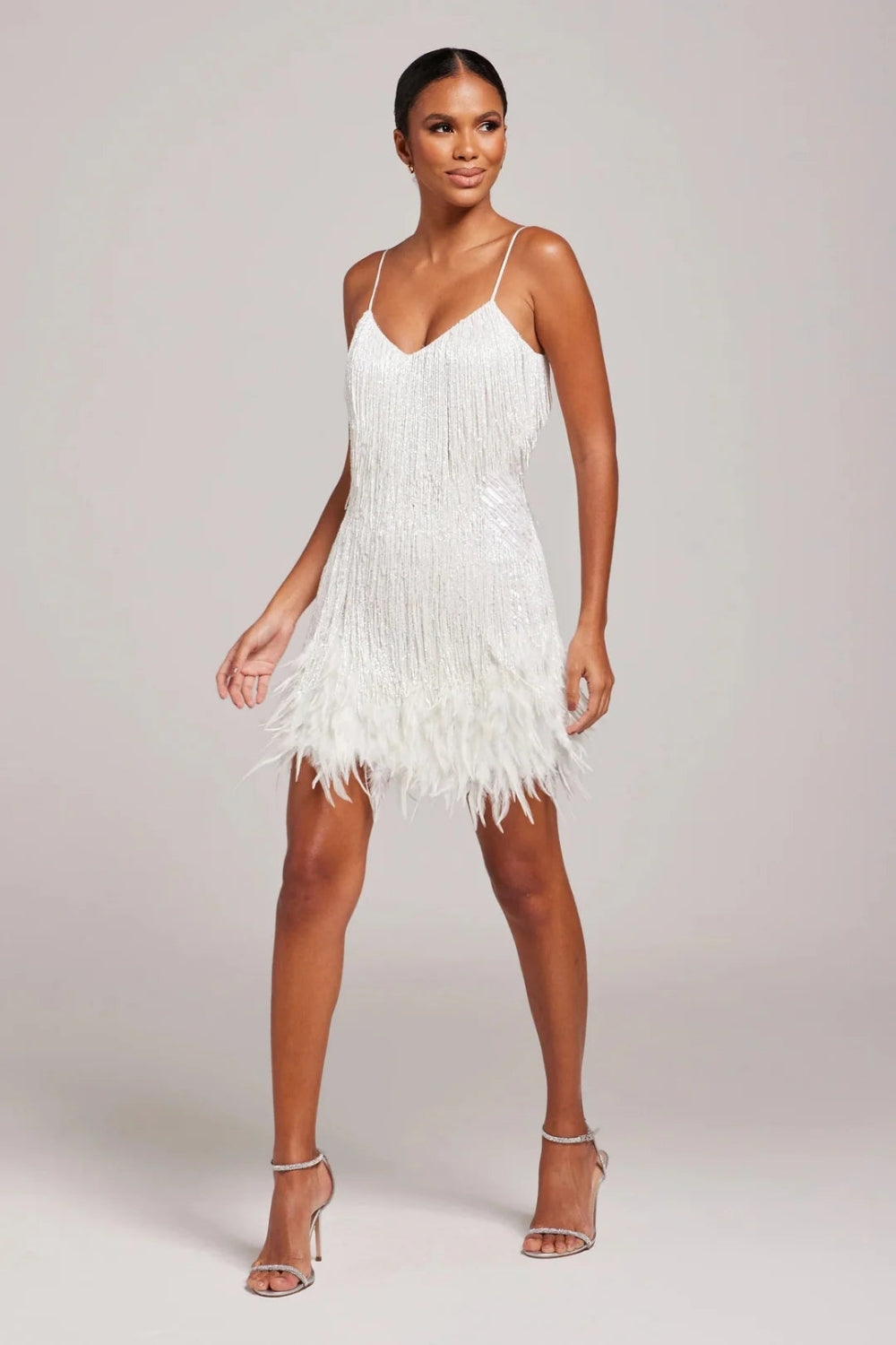 Fashionable women's fringe feather mini dress, a trendy spaghetti strap party and cocktail outfit.