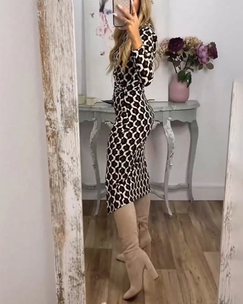 Stylish women's midi dress with vibrant geometric print, flattering ruched bodice, and elegant thigh slit.