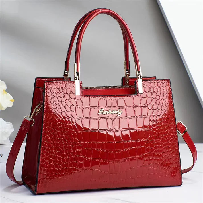 Fashion statement women's handbag, boasting a glossy finish & elegant design. Perfect for a chic modern style.