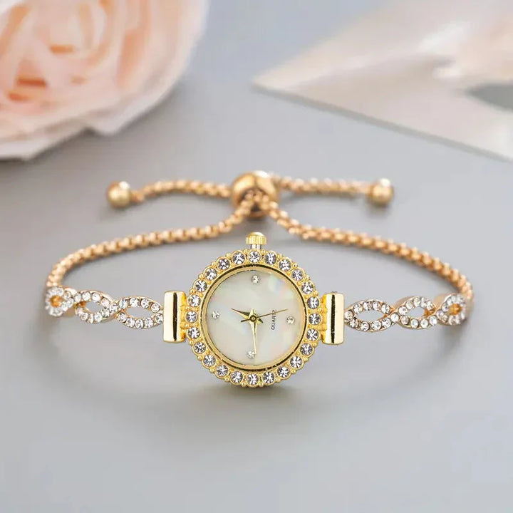 Close-up of a women's silver bracelet watch with sparkling crystal accents.