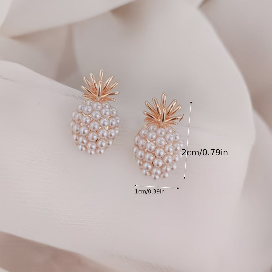 Dainty women's pearl pineapple drop earrings with gold accents. Tropical and elegant fashion accessory.