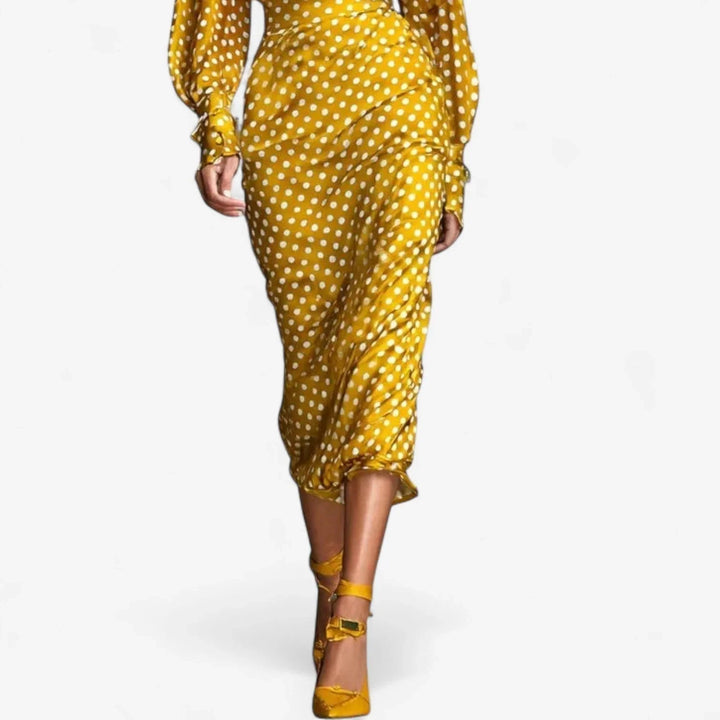 Chic women's polka-dot midi dress with a sophisticated tie-neck and trendy puffed sleeves, perfect for events.
