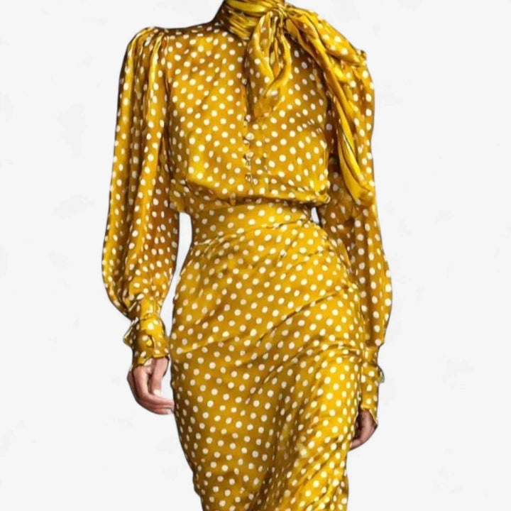 Stylish gold polka-dot midi dress for women, boasting a fashionable tie-neck and elegant puffed sleeves.