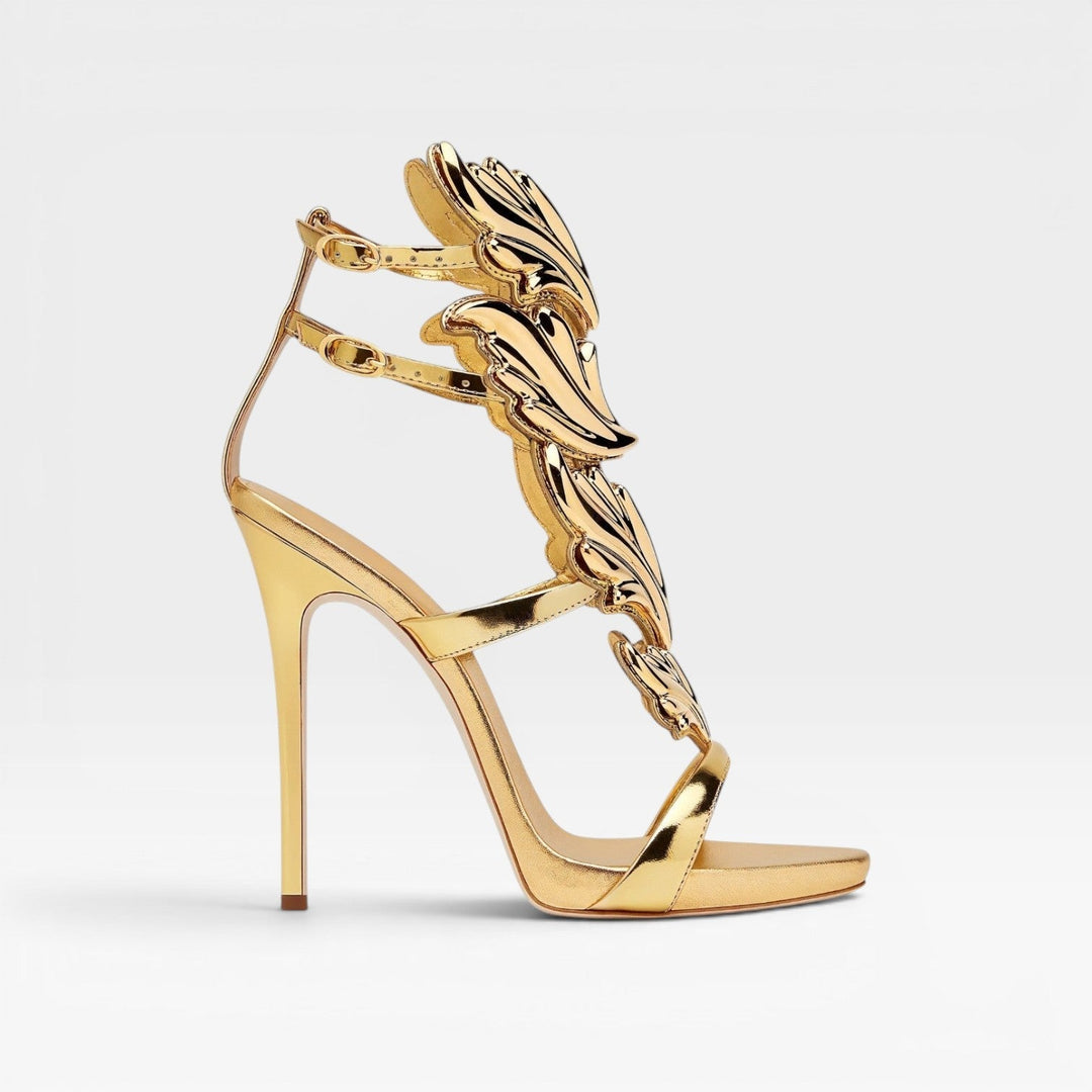 Women's gold high heel stiletto sandals with unique sculptural wing detail and ankle strap.