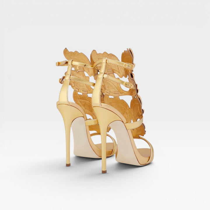 Glamorous gold stiletto heels with a distinctive sculptural wing, ideal for special occasions and parties.