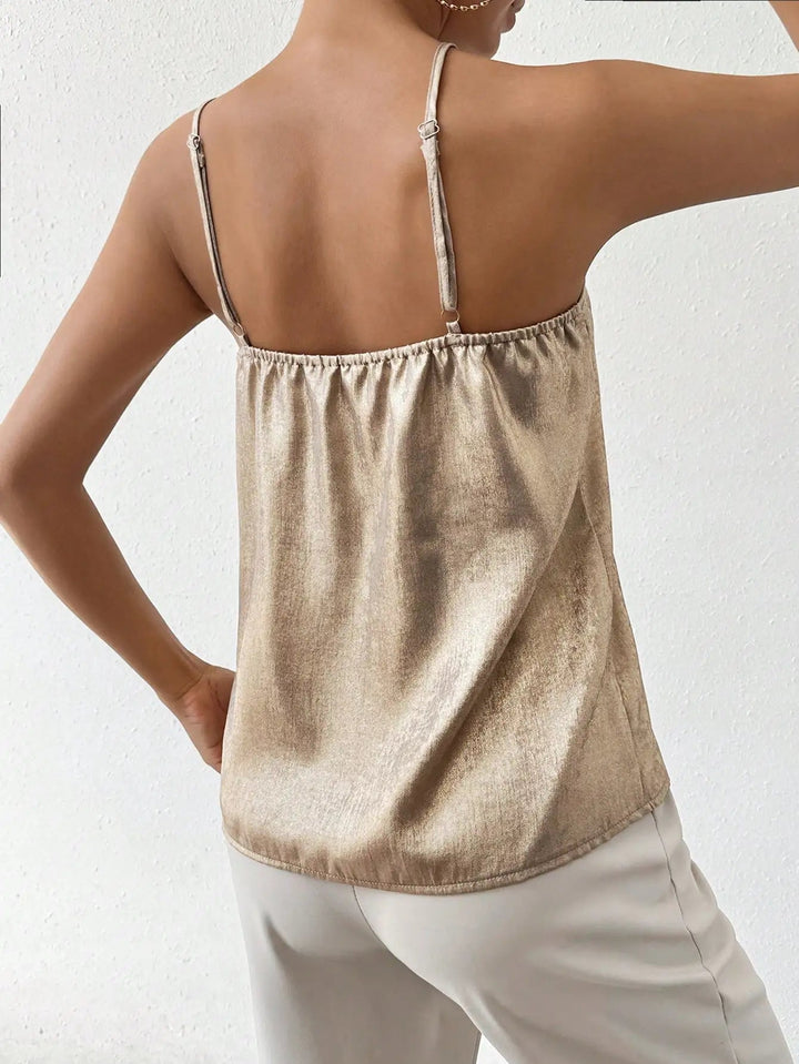 Women's gold shimmering V-neck top with thin, adjustable straps, an elegant choice for evening events.