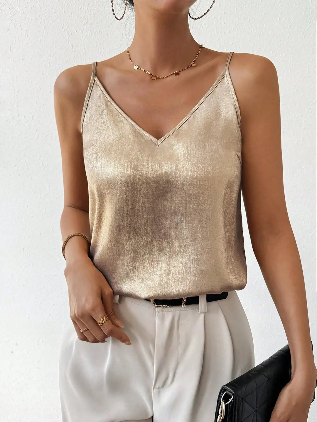 Stylish women's shimmering V-neck cami top, a versatile party top with adjustable spaghetti straps.