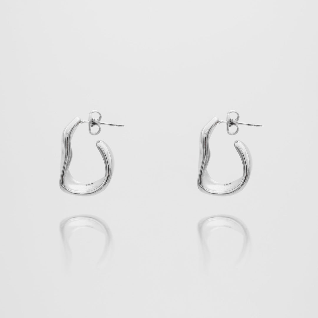 Women's textured half hoop earrings featuring both gold and silver finishes, sophisticated design.