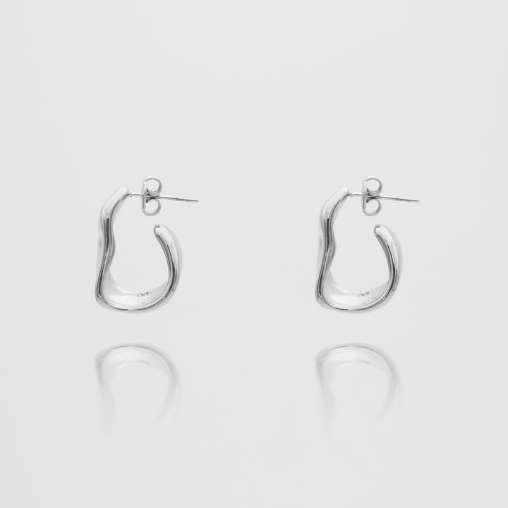 Women's textured half hoop earrings featuring both gold and silver finishes, sophisticated design.