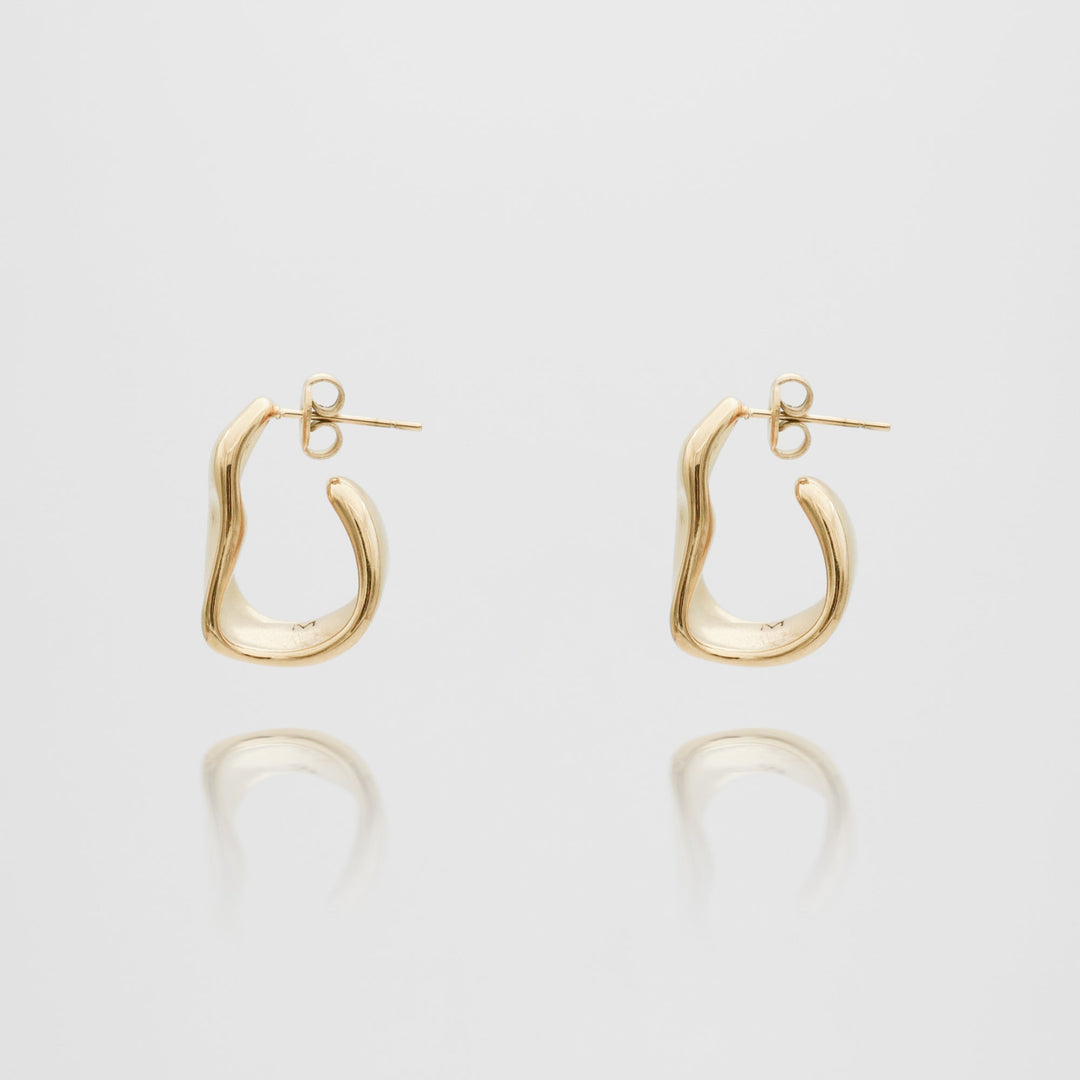 Women's elegant textured half hoop earrings in gold and silver, perfect for any occasion.