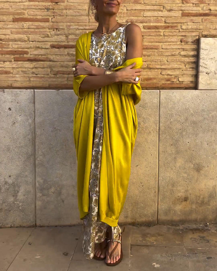 Women's elegant golden maxi dress with a flowy design, perfect for glamorous evening wear and summer occasions.