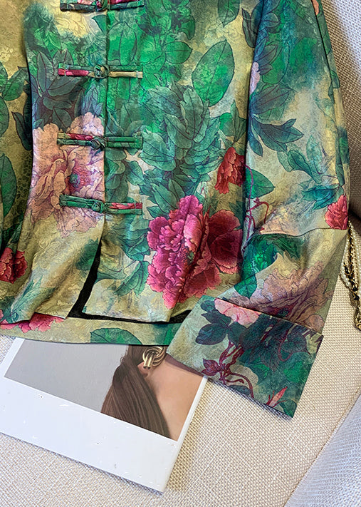 Model wearing an elegant women's green silk blend coat with a vibrant button print. Sophisticated and warm outerwear for autumn and winter.