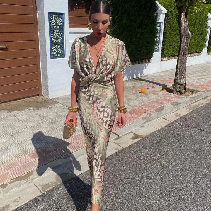 Elegant women's green V-neck animal print maxi dress with short sleeves, perfect for evening wear or summer occasions.
