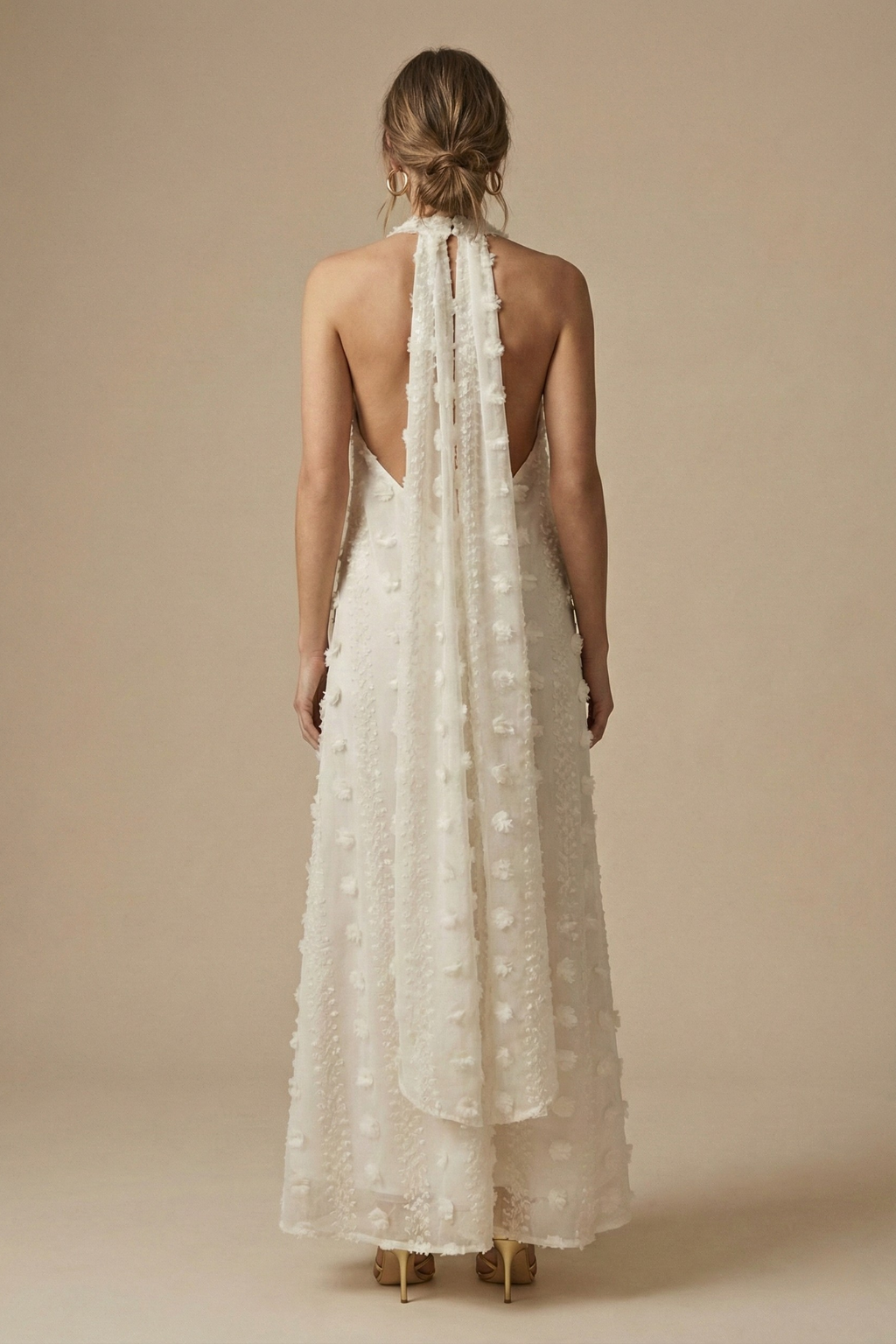 Stunning backless halter maxi dress with intricate floral appliqué, a beautiful choice for evening wear or special events.