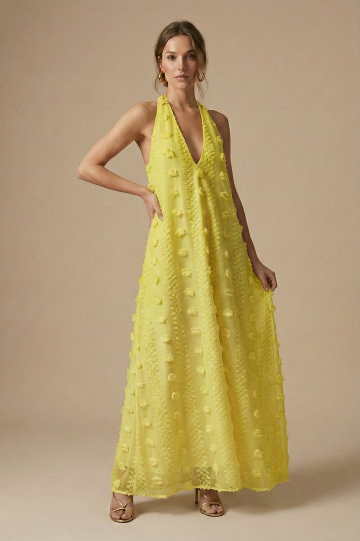Fashionable women's halter backless maxi dress with charming floral appliqué. A must-have for elegant summer fashion.