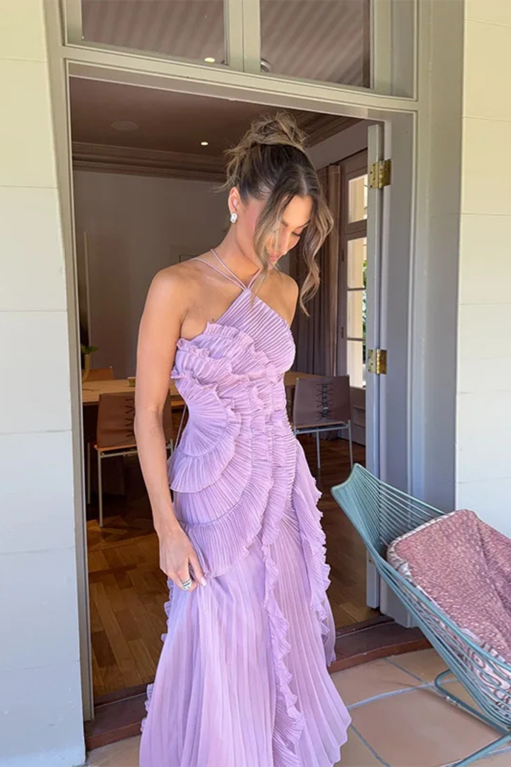 Gorgeous women's summer occasion dress: backless halter, ruffled details, and a graceful maxi length.