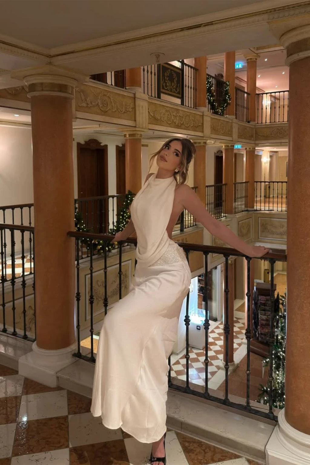Flowing draped halter neck maxi dress, an elegant sleeveless evening gown for women's formal occasions.