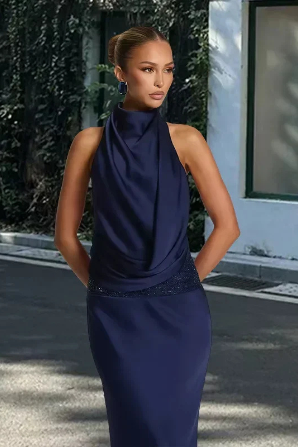 Elegant long maxi dress with a halter neck and draped details, perfect for wedding guests & formal wear.