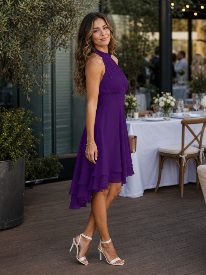 Stylish women's halter neck dress, knee-length with a flowy layered hem, perfect for party or elegant casual events.