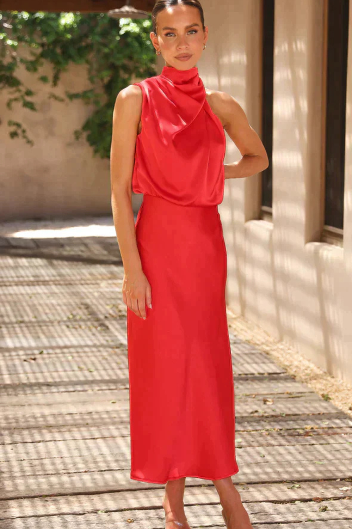 Refined women's sleeveless formal dress with a chic halter neck, perfect for celebrations.