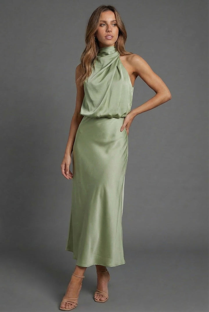 Graceful women's open-back midi dress with a halter neck, ideal for wedding guests.