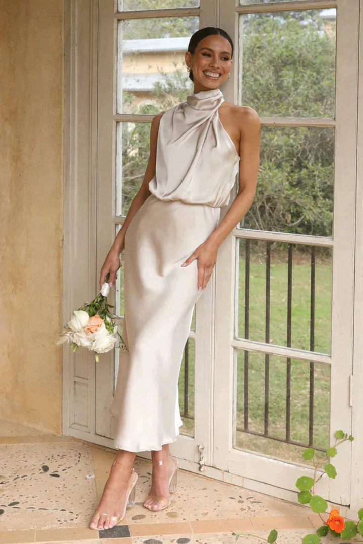 Sophisticated sleeveless midi dress with a flattering halter neck for women's evening events.