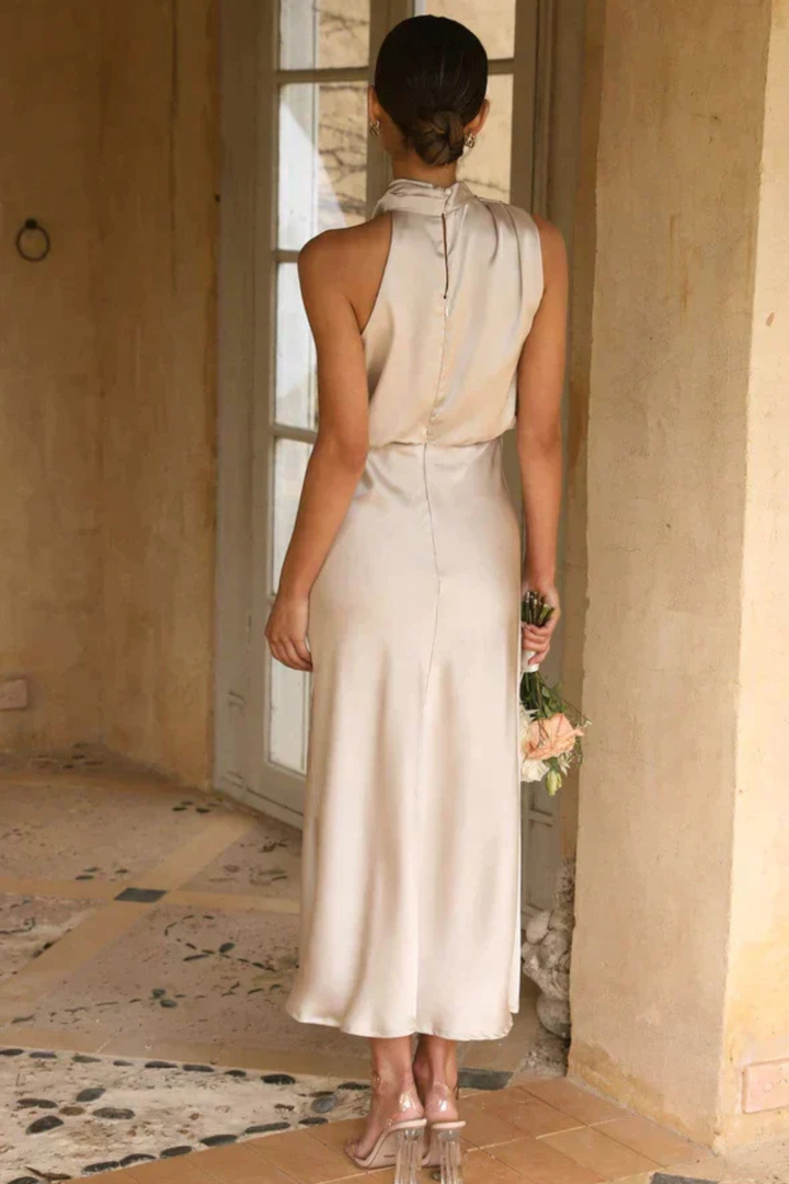 Chic formal midi dress featuring a stylish halter neckline, ideal for wedding guest attire.
