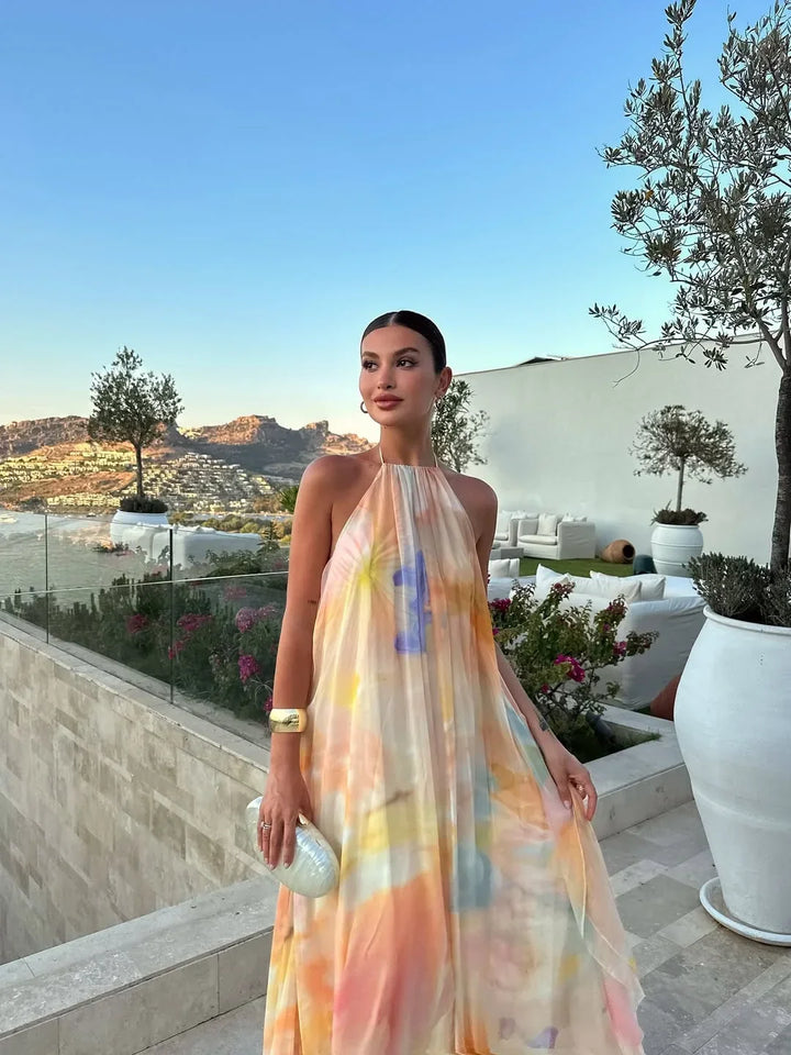 Vibrant watercolor print halter neck maxi dress for women, ideal as an elegant summer or evening party dress.