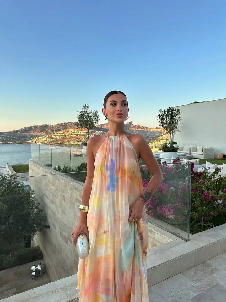 Chic women's open back maxi dress with a flowy A-line silhouette and stunning watercolor print.
