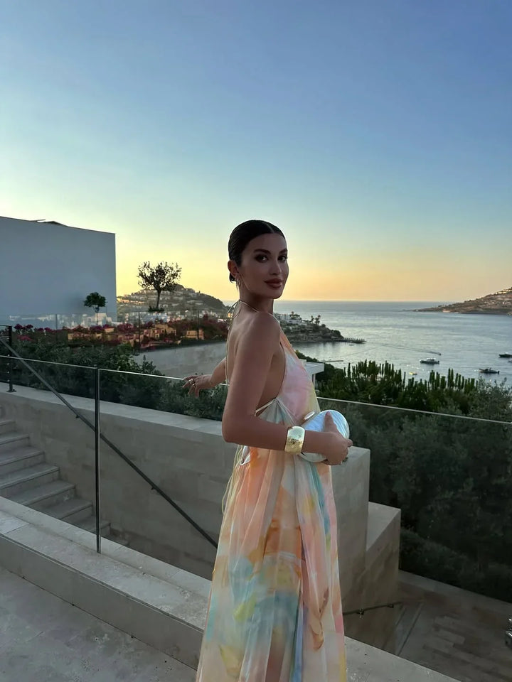 Fashionable women's halter neck summer maxi dress, showcasing a beautiful abstract watercolor print.
